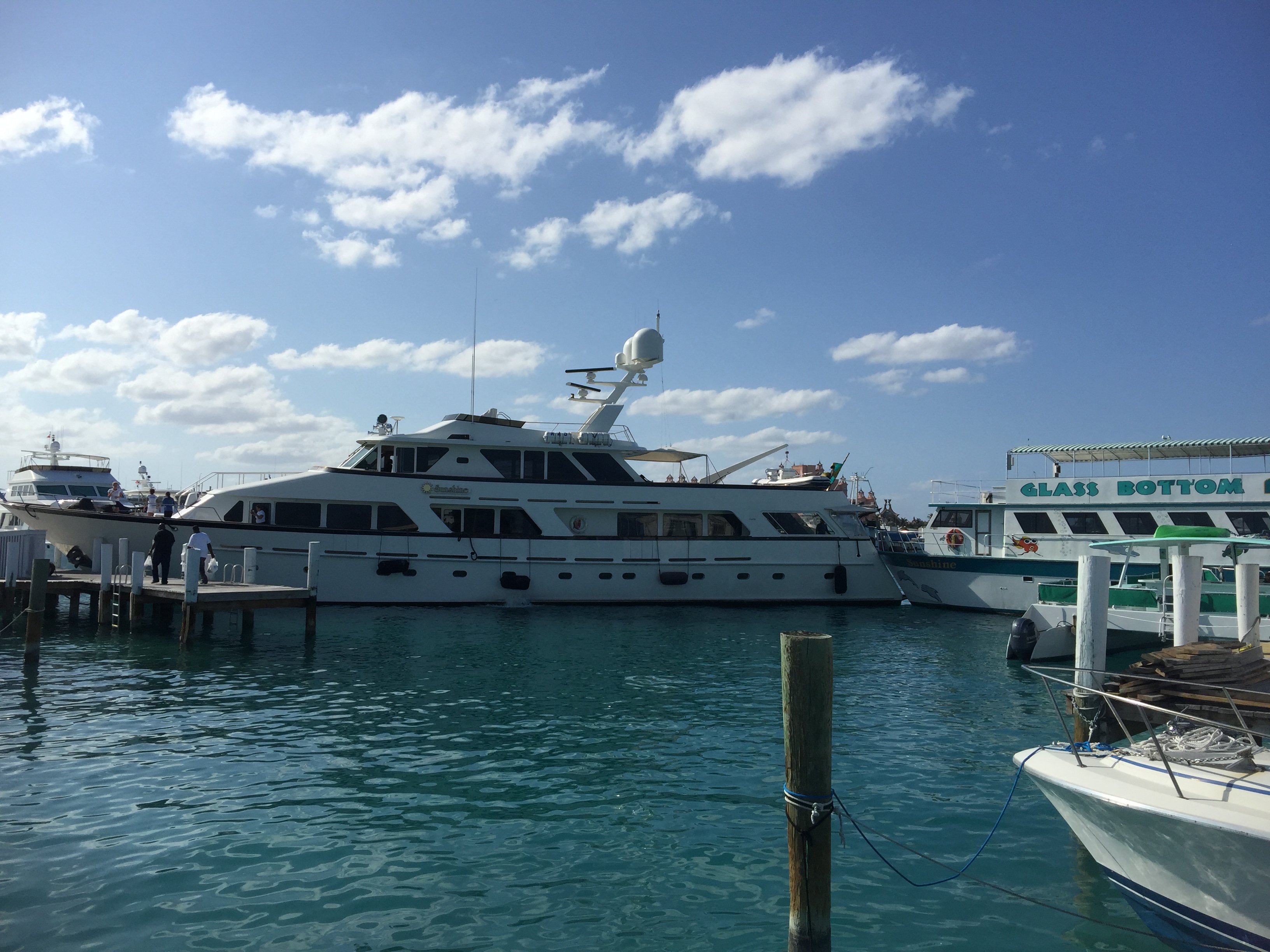 Superyacht Sunshine wedged between the dock and the tour boat Sunshine