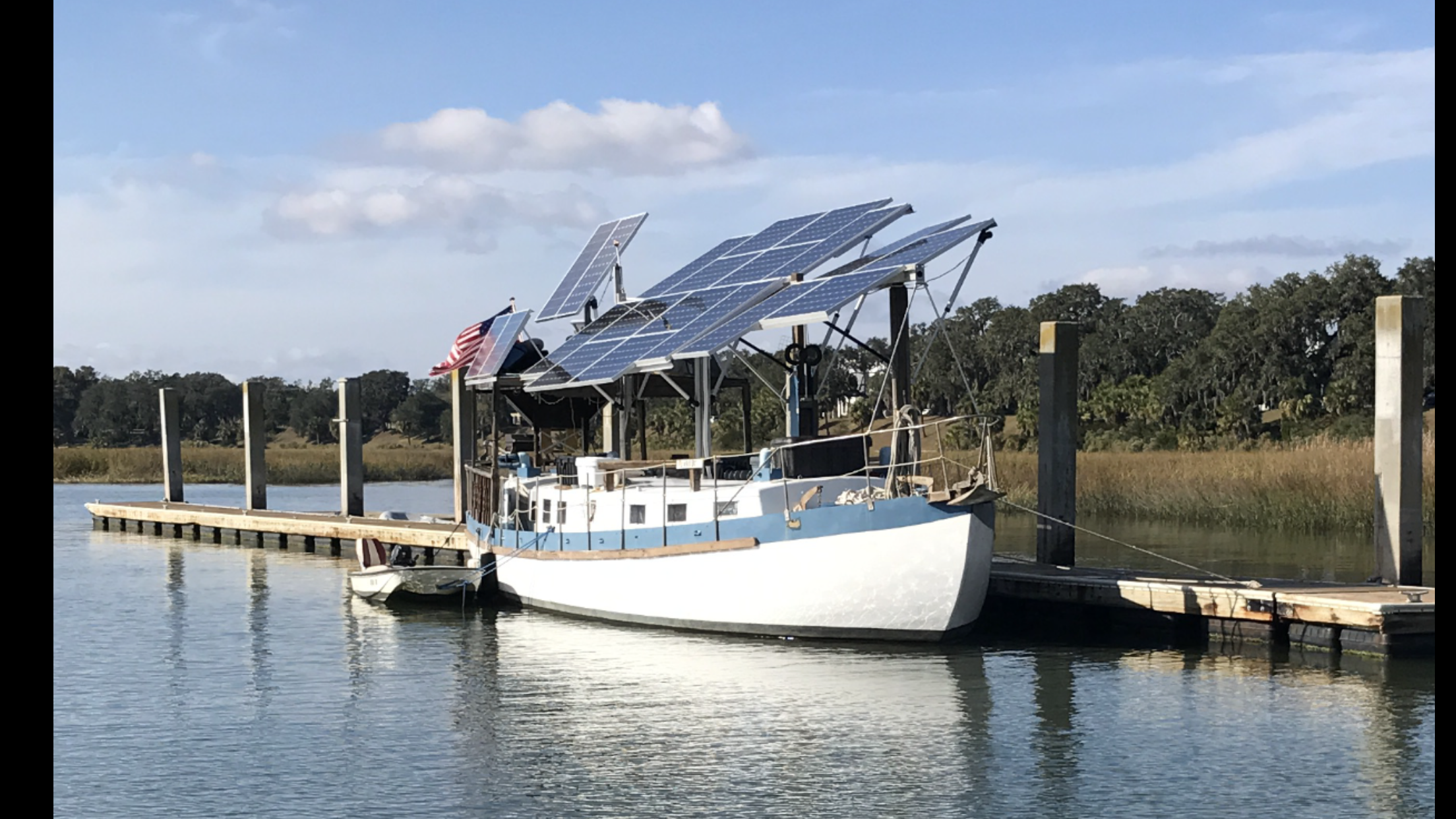A converted sailboat with lots of solar panels.