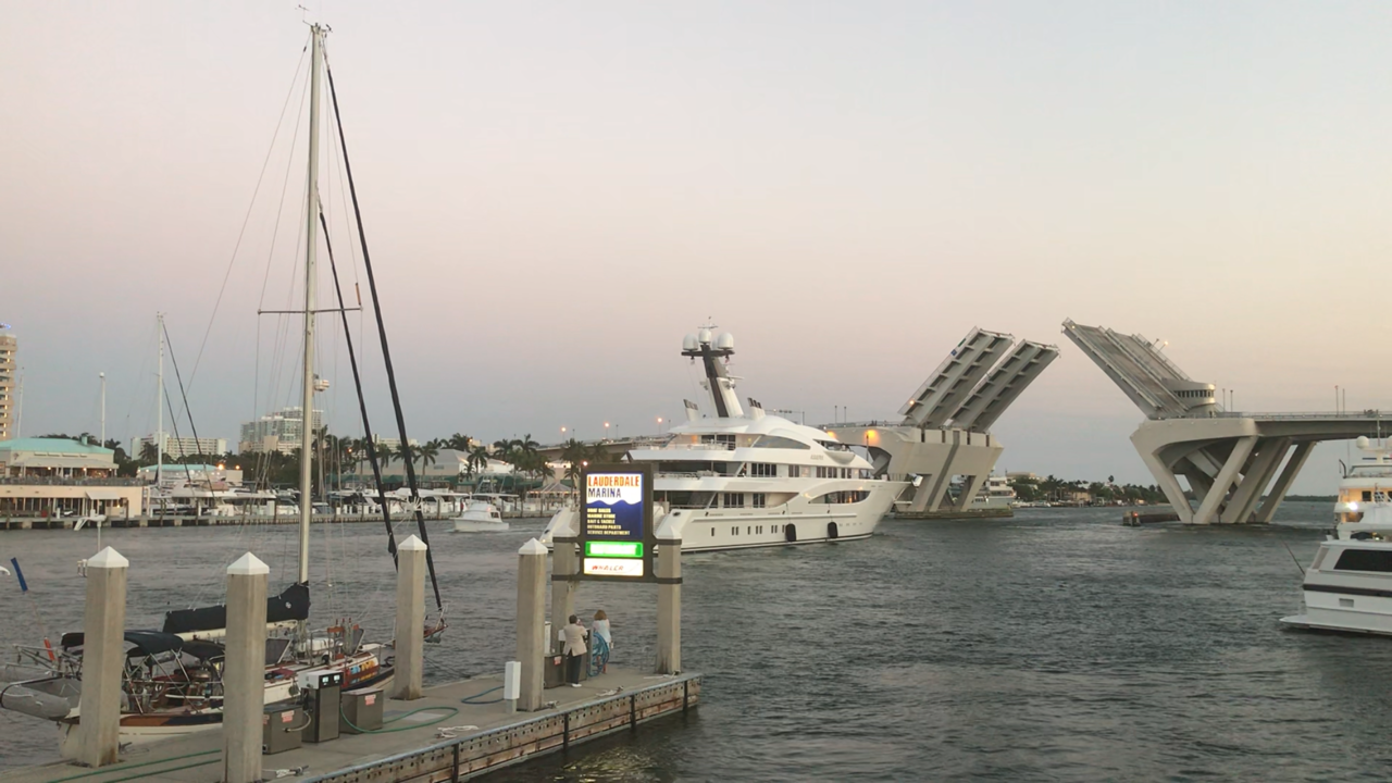 A superyacht owned by a Russian oligarch goes through the Fort Lauderdale bridge while Sophia rests at the dock.